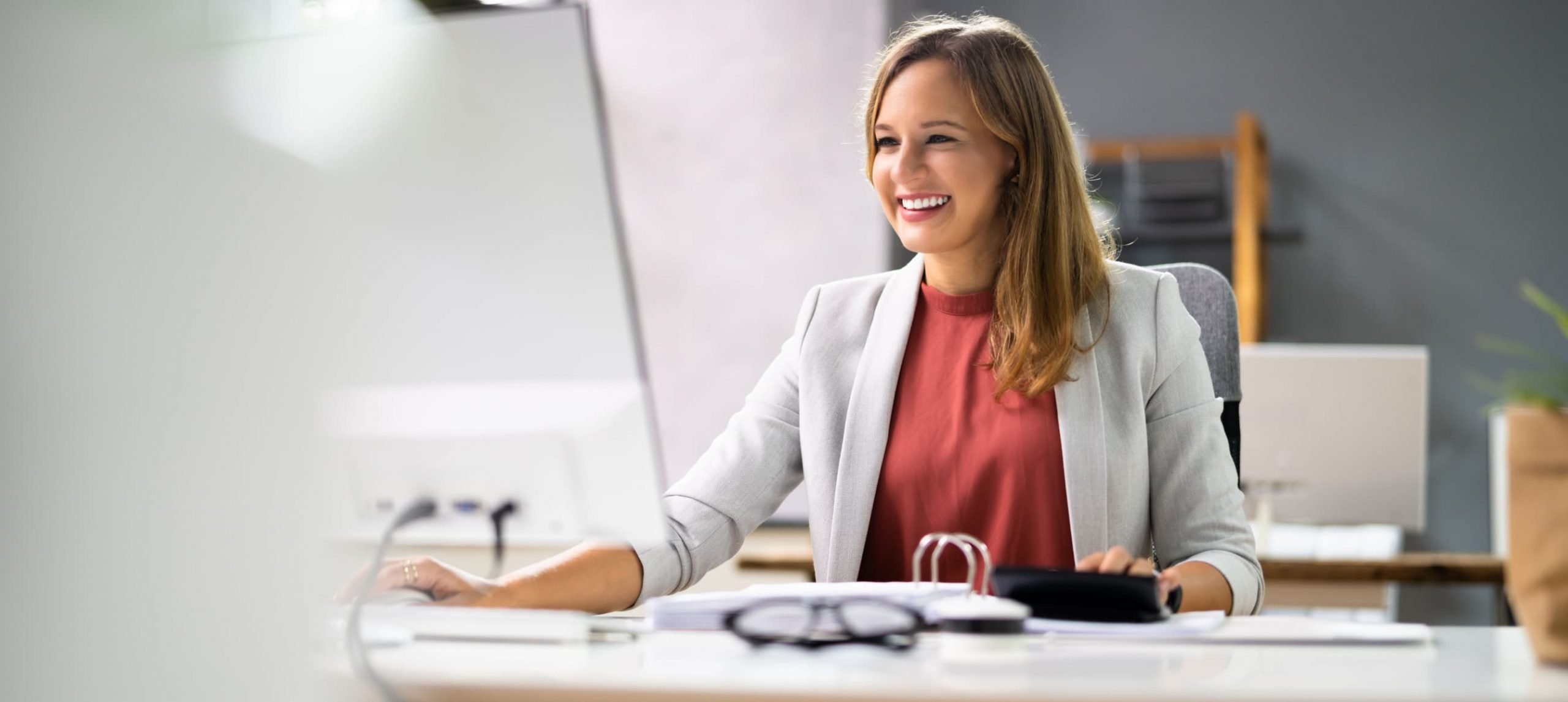 a woman sitting at her work desk