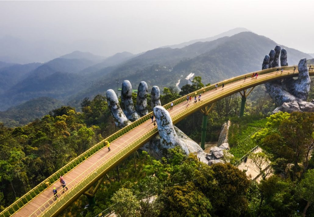 The Golden Bridge is lifted by two giant hands in the tourist resort on Ba Na Hill in Danang, Vietnam.