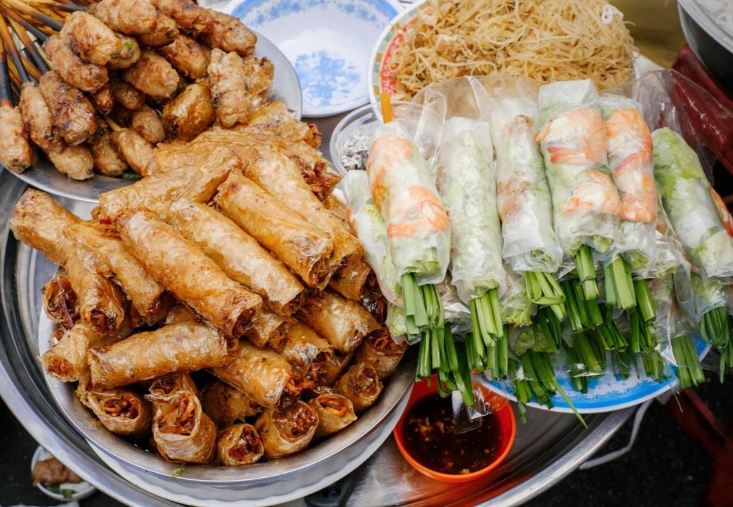 Vitnemese fresh and fried spring rolls on a street food stall.