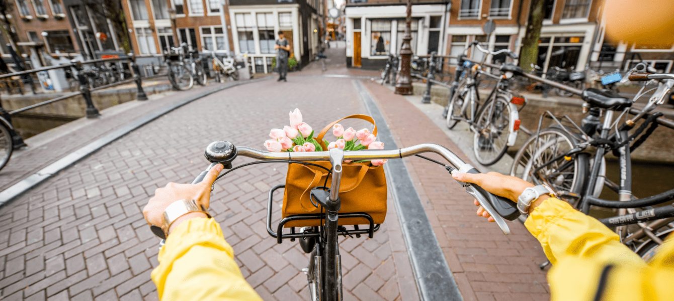 A young girl riding a bike in the streets of Amsterdam, Netherlands.