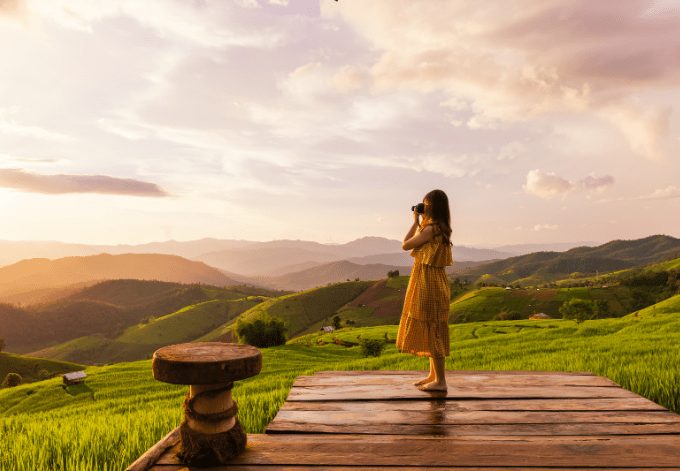 Young woman relaxing in green rice terraces on holiday at pabongpaing village, Mae-Jam Chiang mai, Thailand