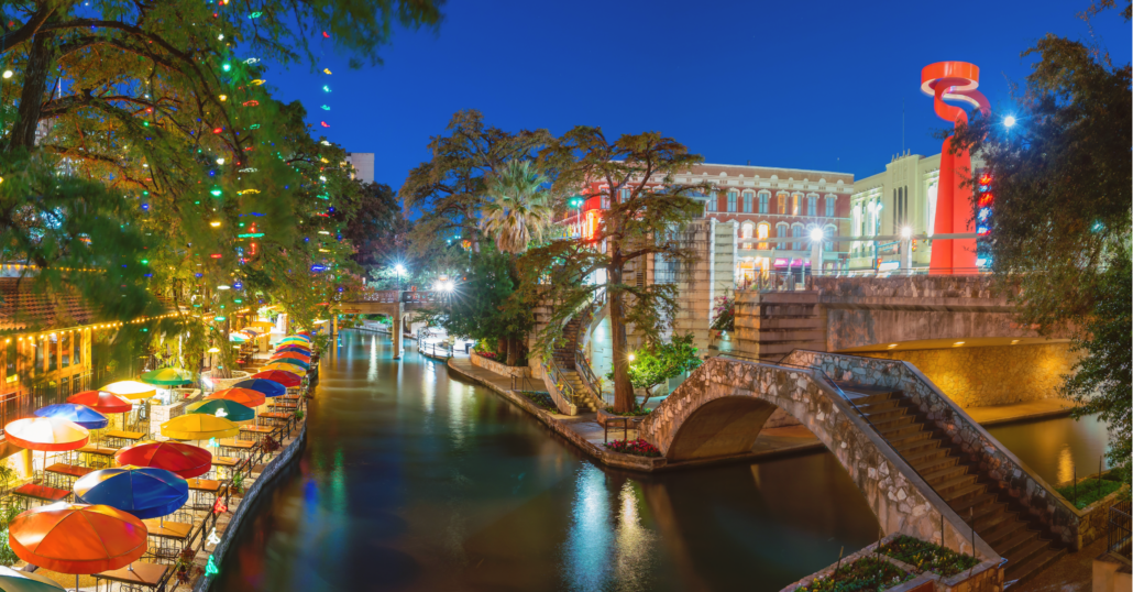 The San Antonio River Walk lined by restaurants and bars during the night.