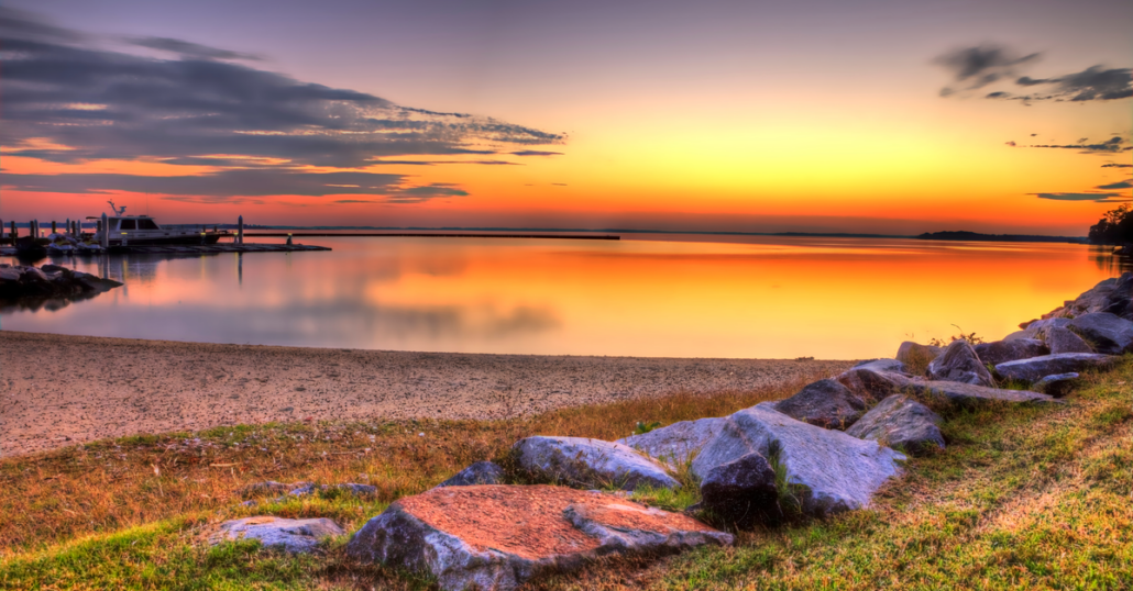 Red and orange sky during a sunset by the river.