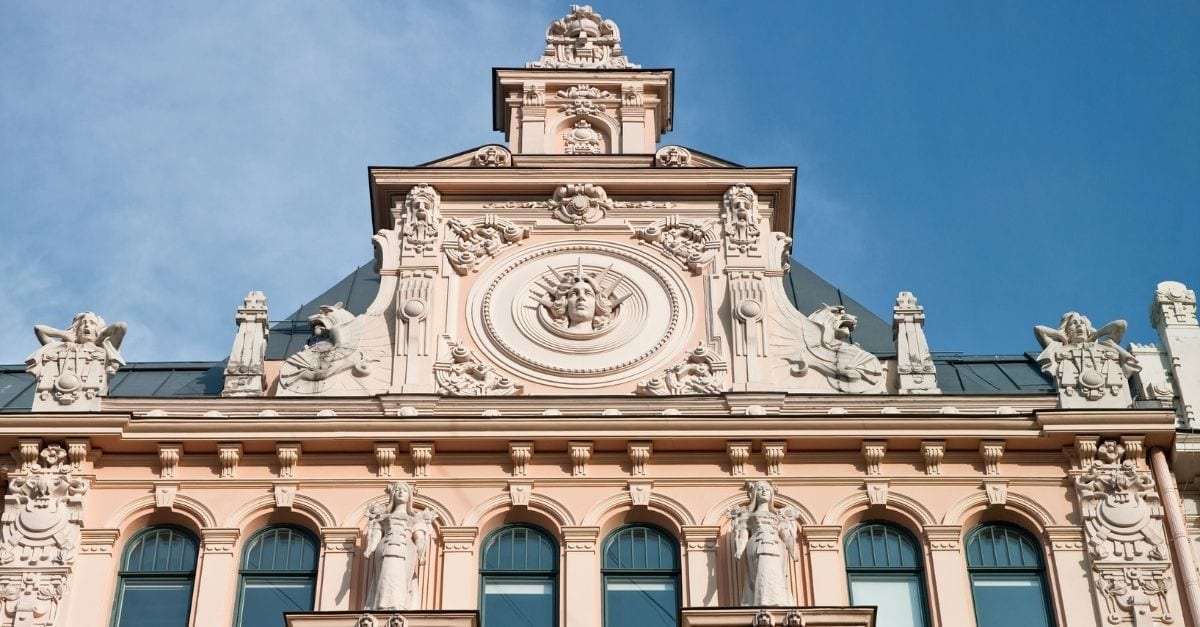 Light pink façade of an ornamented Art Nouveau Building.