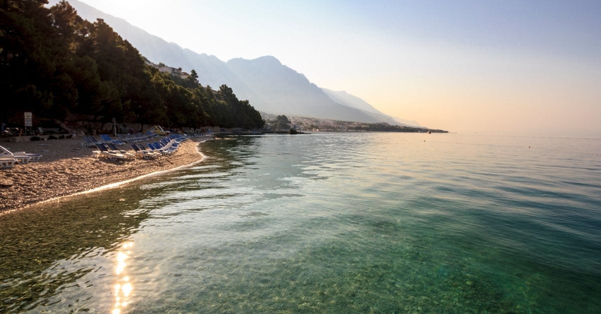 A pebbly beach in Croatia at dusk.