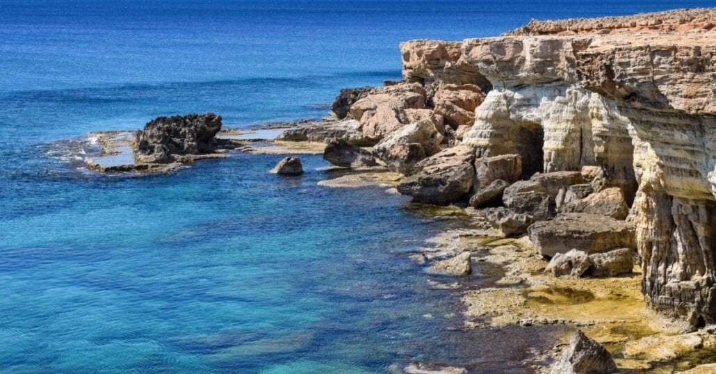 A rock cliff near the blue ocean in Cyprus.