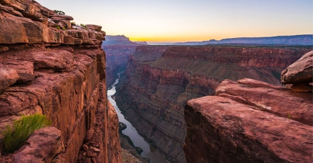View of some of Grand Canyon’s red-coloured rocks during an orange sunset.