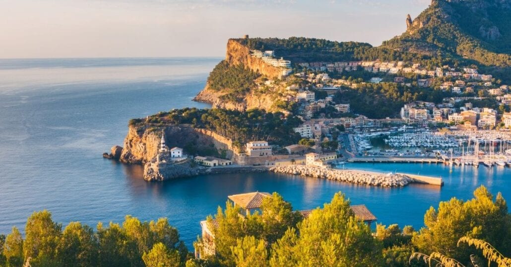 Aerial view of Balearic Island's landscape wth forested hills by the ocean.