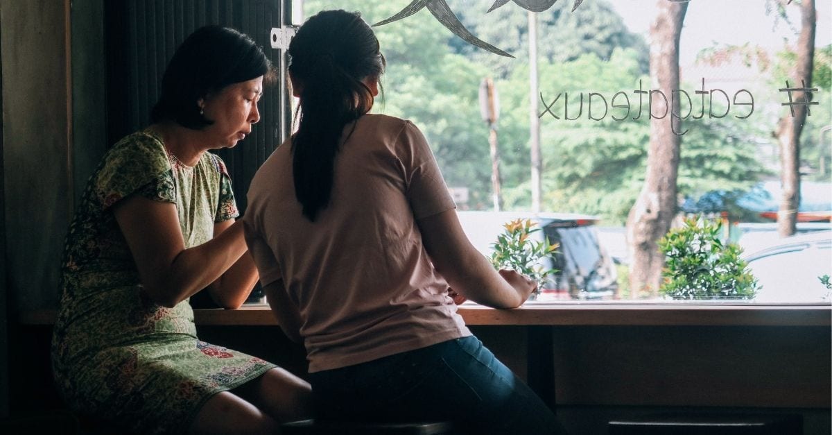 Mother and daughter inside a cafe.