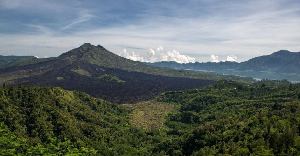 View of the Mount Batur surrounded by verdant forests. 