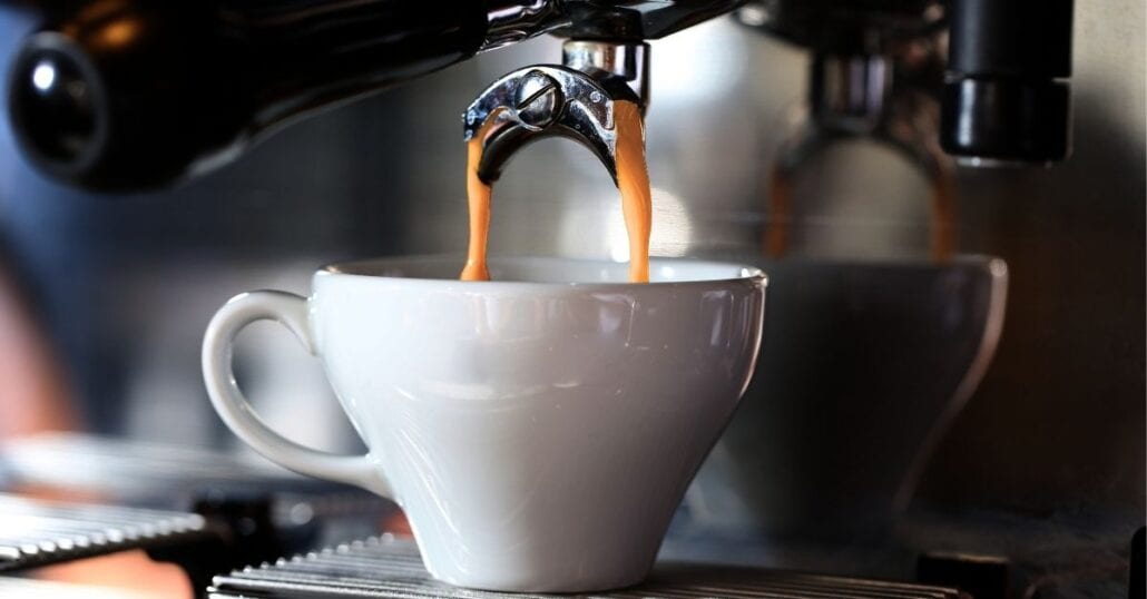 A cup of espresso coffee being made.