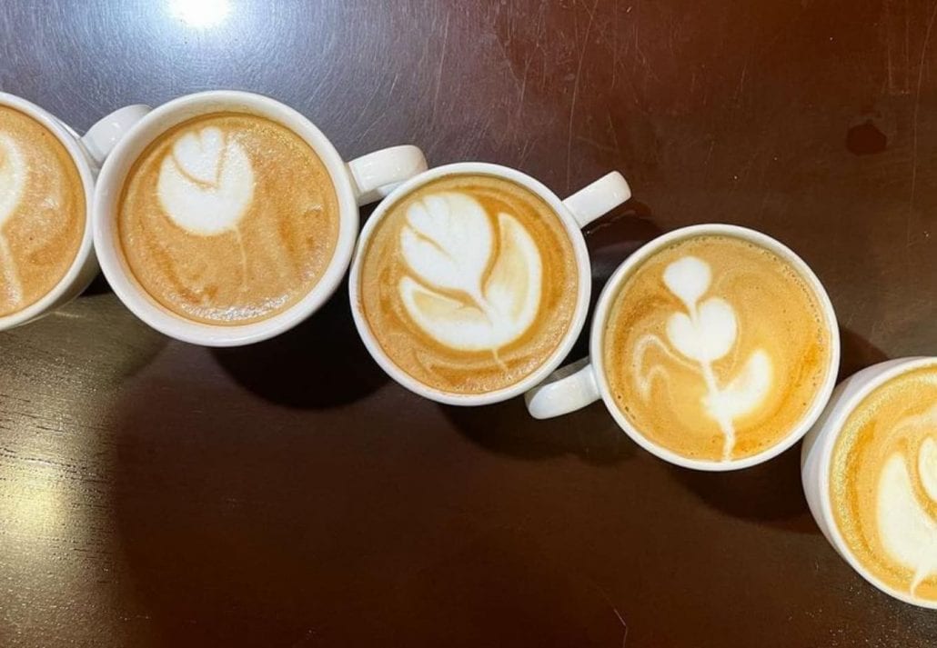 5 lattes on top of a table at R&R Coffee Cafe, Colorado.