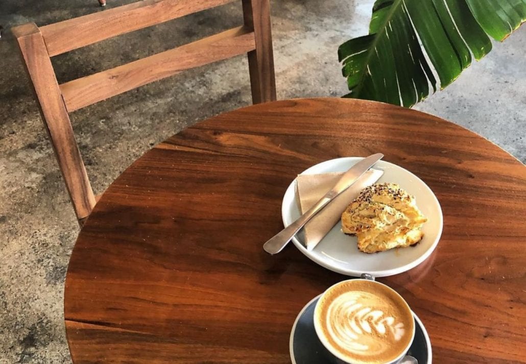 Cup of coffee and a pastry on a table at Stpaway Coffee, in Colorado.