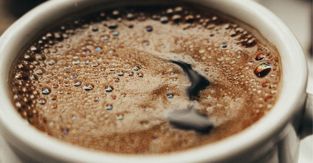 Close up on a cup of warm, black coffee. 