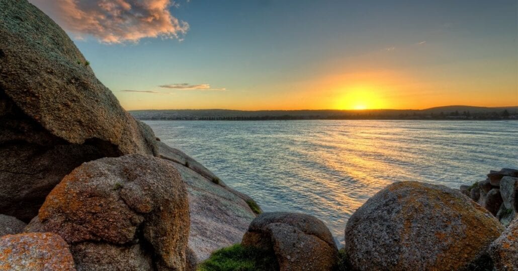 An orange sunset at Victor Harbour Beach, in Australia.