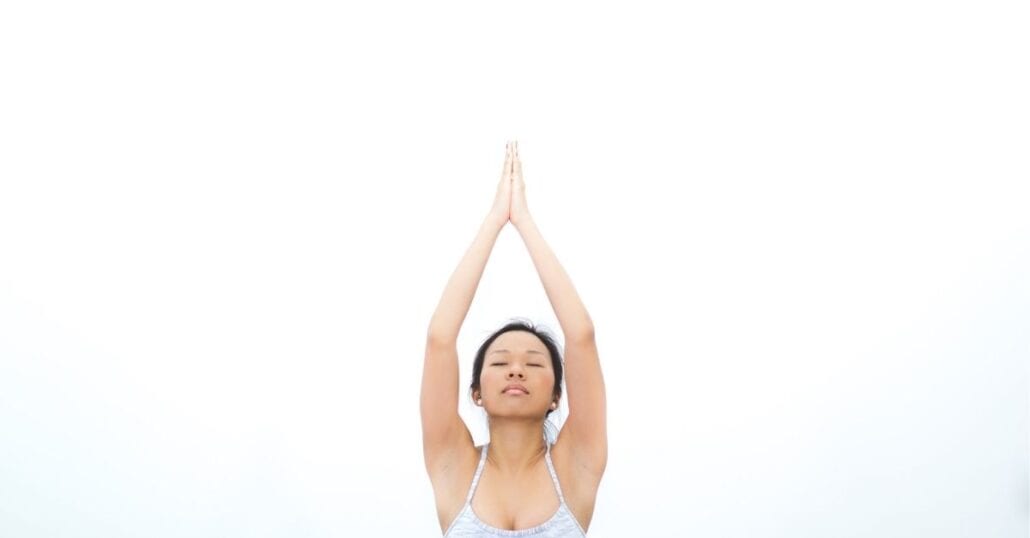 yoga.jpg | CuddlyNest Travel Blog Woman doing yoga with her eyes closed.