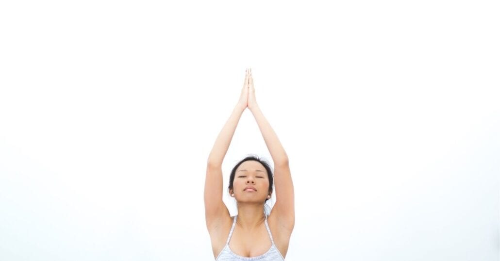 Woman doing yoga with her eyes closed.