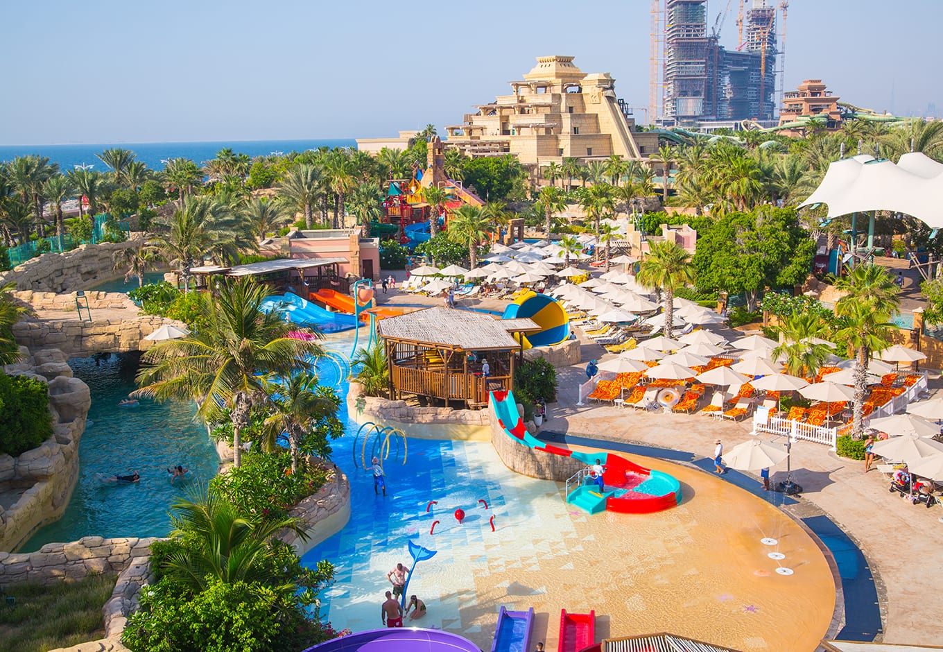 The waterslides and pools surrounded by trees at the Aquaventure, Waterpark, Dubai.