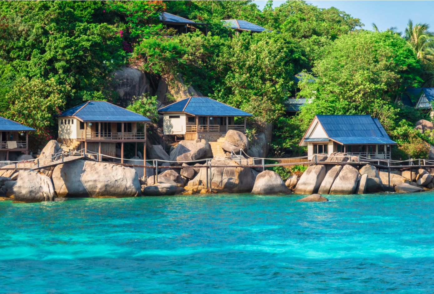 Bungalow over water with tropical vegetation in background in Ko Tay, Chumphon Gulf of Thailand.
