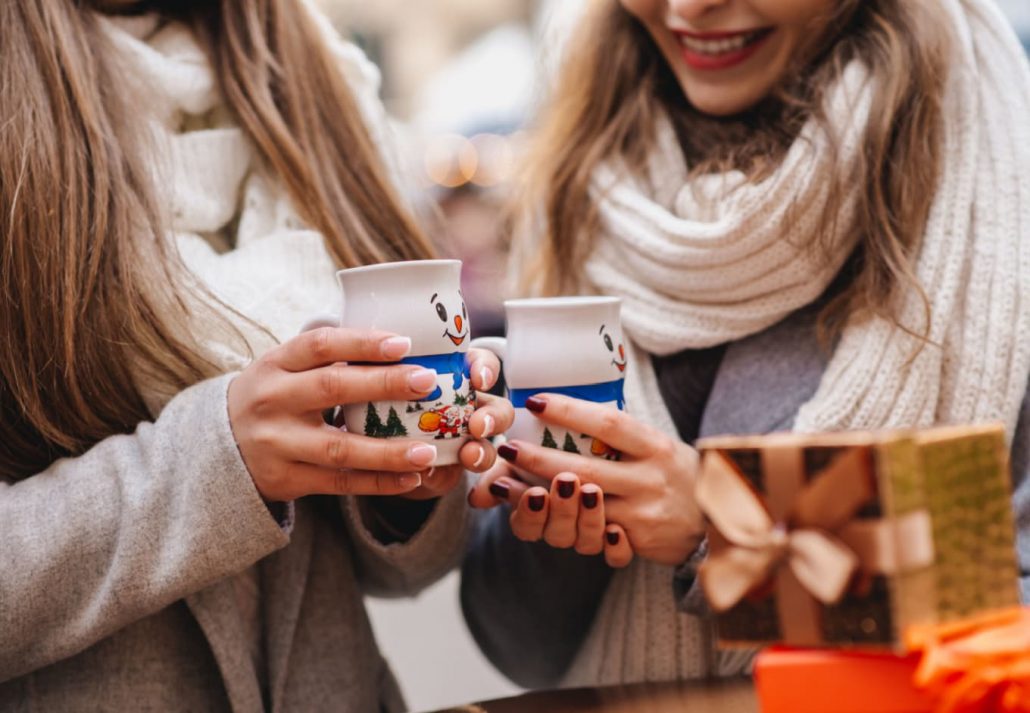 Girls drinking hot chocolate at a Christmas Market