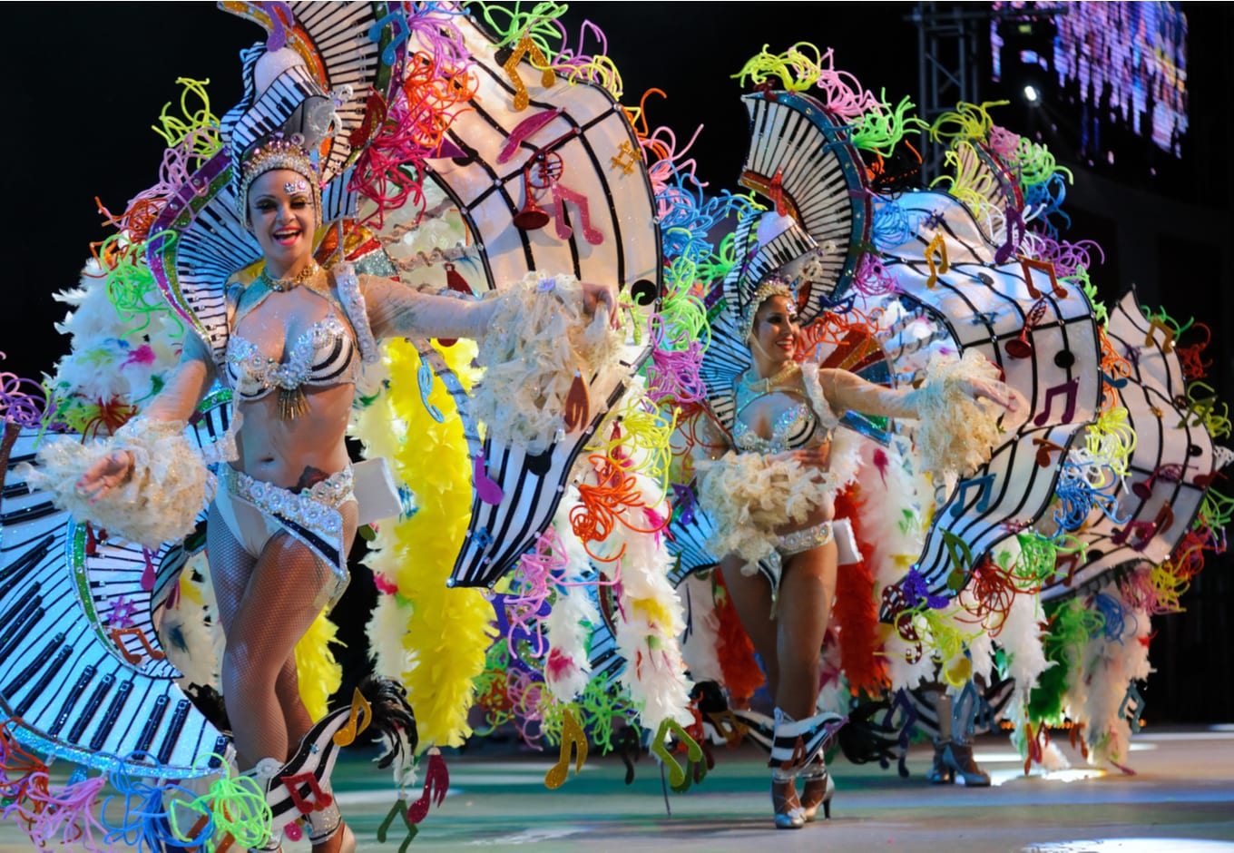 Woman dressed on festive costumes and dancing during the famous Carnival the Santa Cruz de Tenerife, Spain.