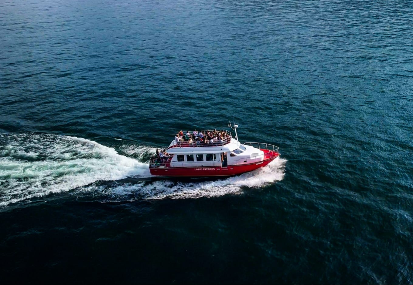 A white and red ferry transporting people.