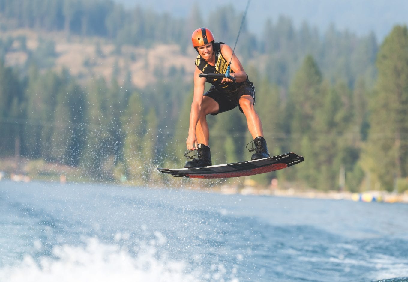 Woman wakeboarding on a lake.