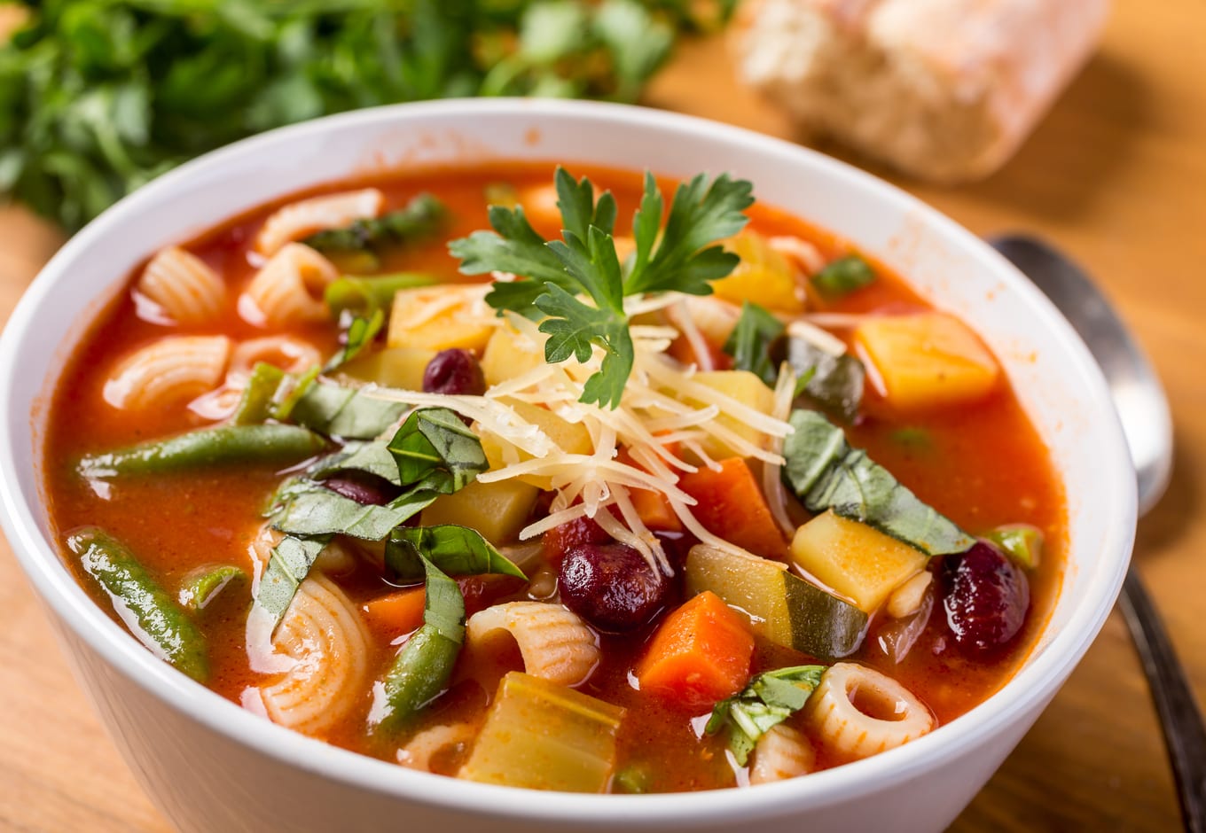 A bowl of Minestrone soup made with vegetables and pasta.