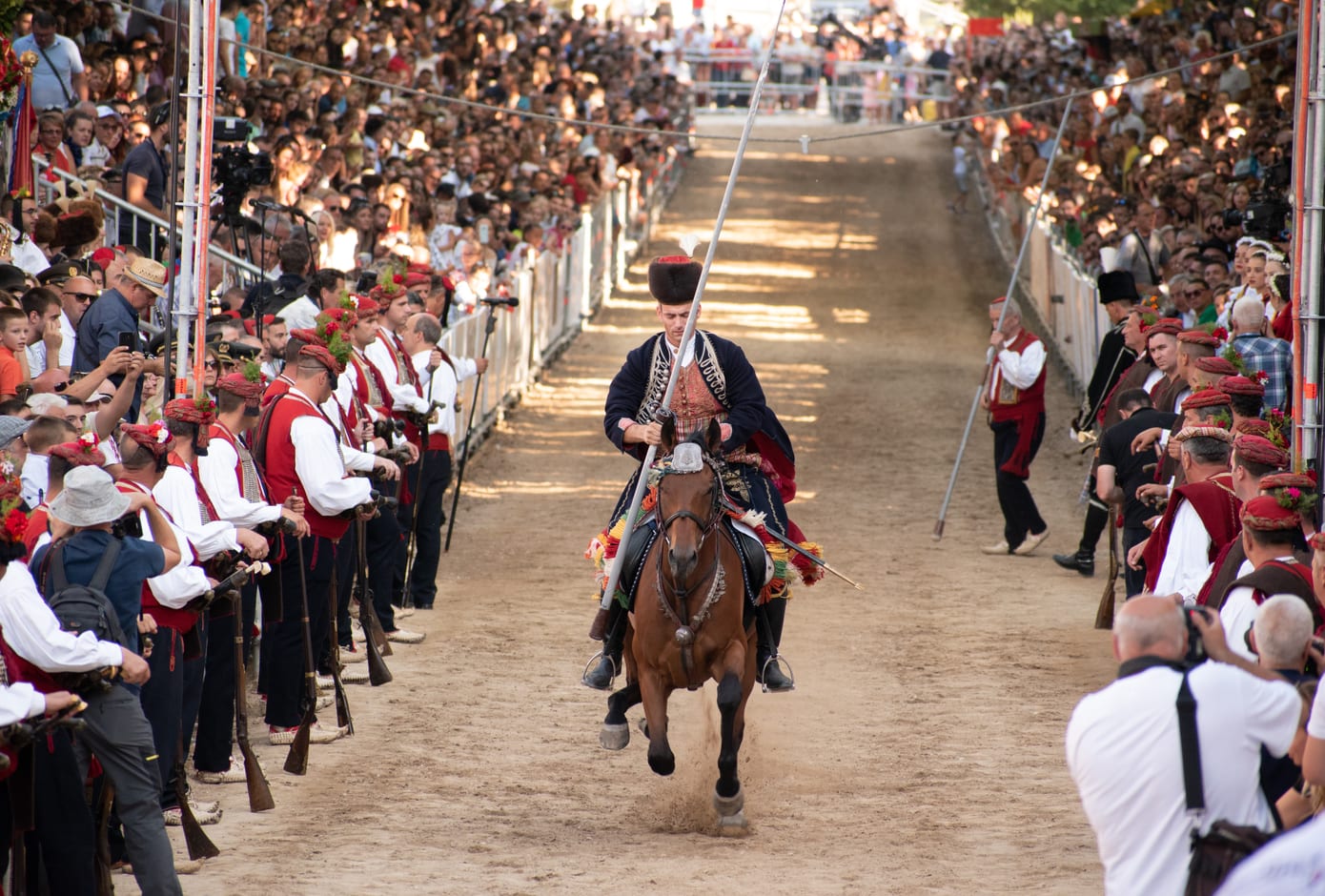 Alkar on his decorated horse galloping, hitting the metal ring  with his spear during Sinjska Alka, tournament, in Sinj
