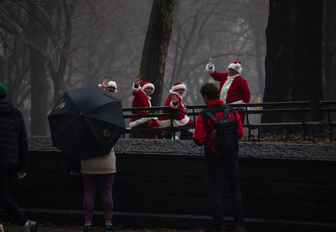 Men dressed in Santa outfits enjoying free outdoor events in NYC's Central Park