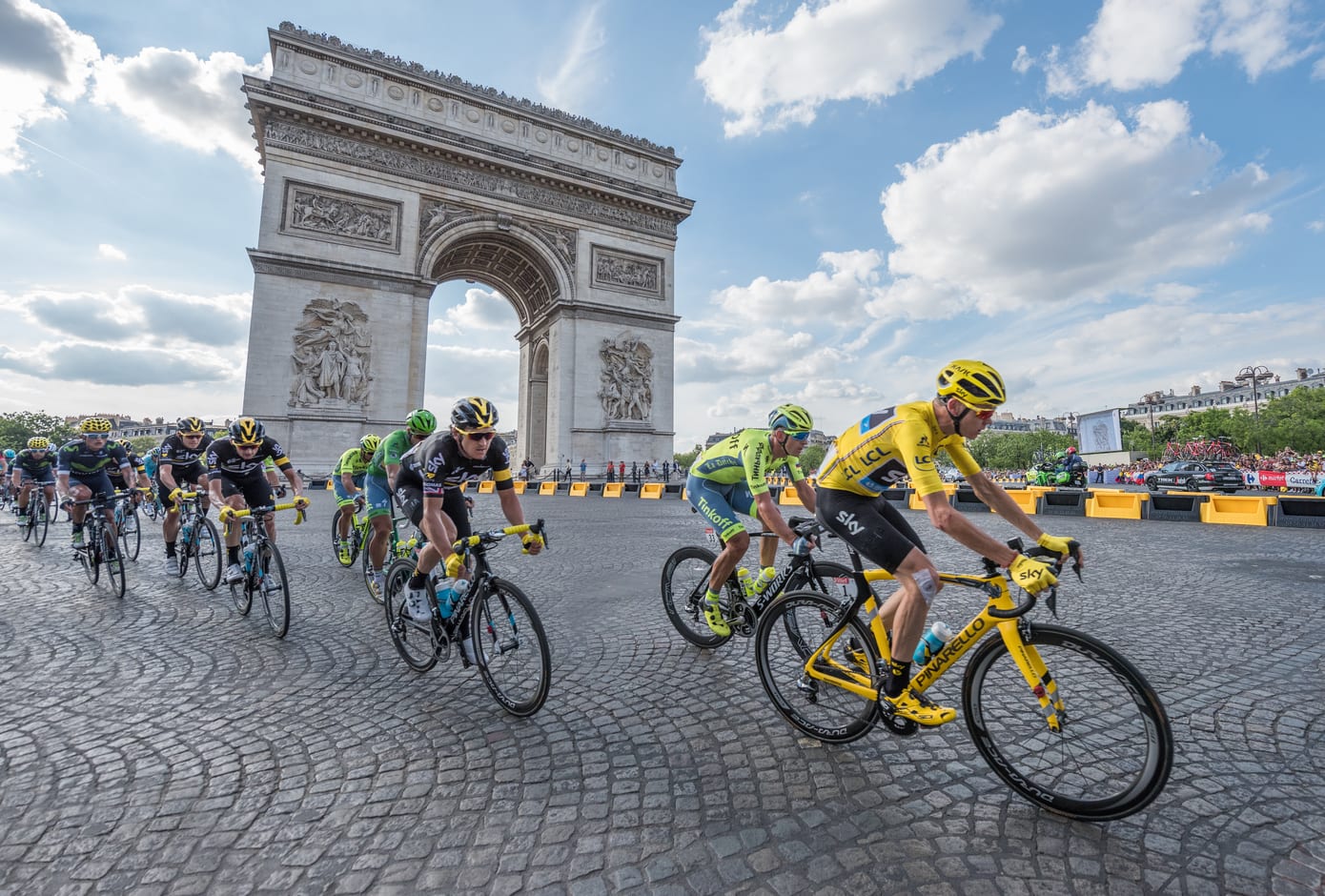 Christopher Froome, wearing the leader's yellow jersey in front of Arc de Triomphe during the Tour de France on the Champs Elysees Avenue.
