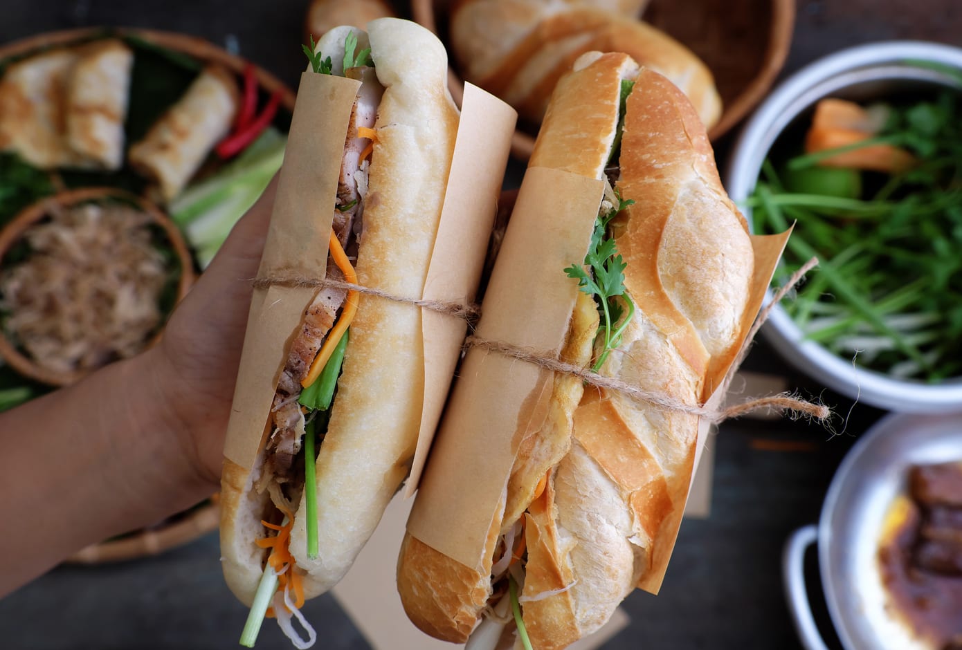 Woman holding a Vietnamese banh mi.