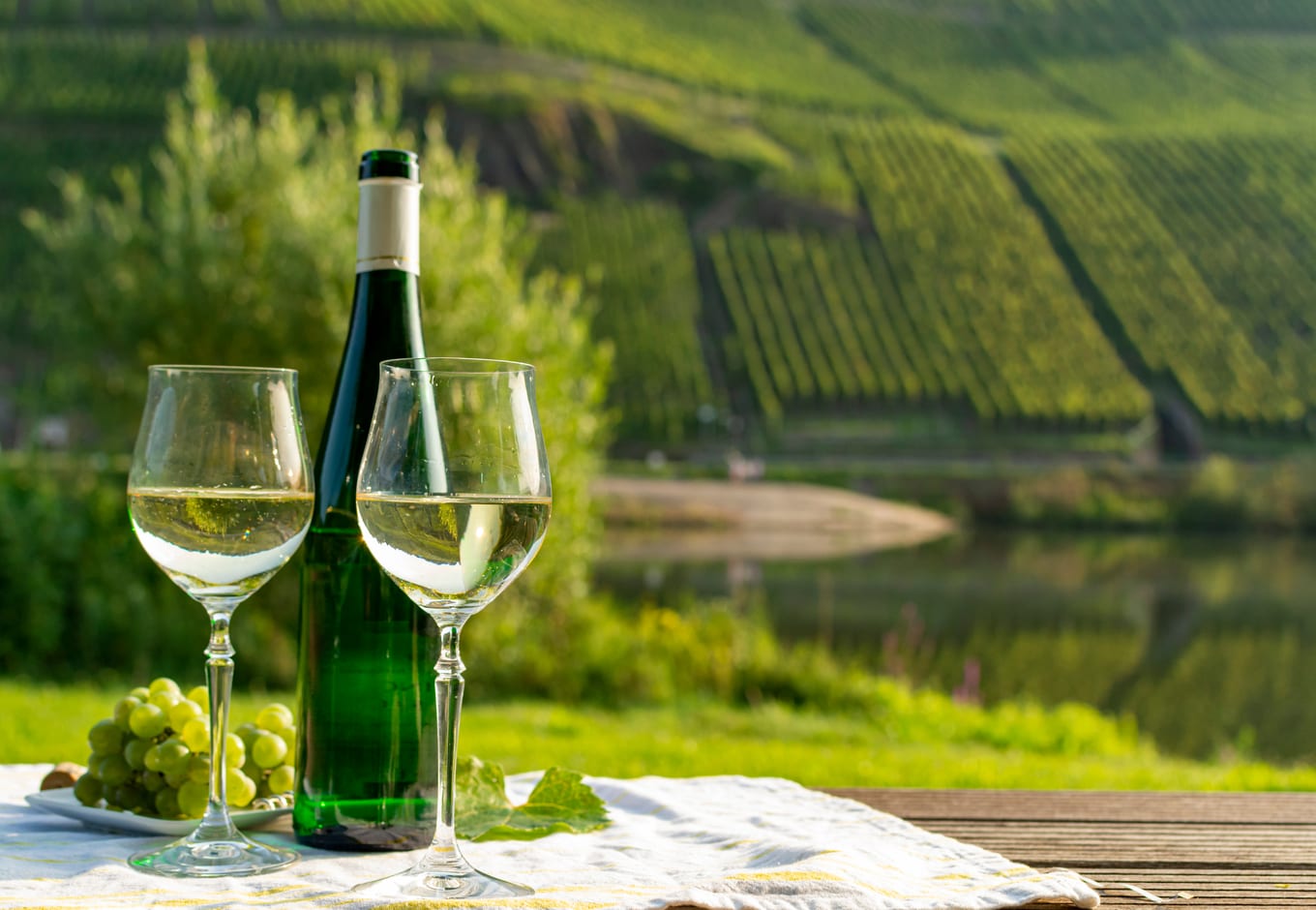 A bottle and two glasses of the German wine riesling.