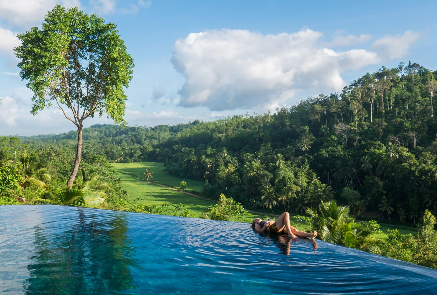 Female traveler lying by the pool at the Luxury Villa Nearby Galle, Sri Lanka