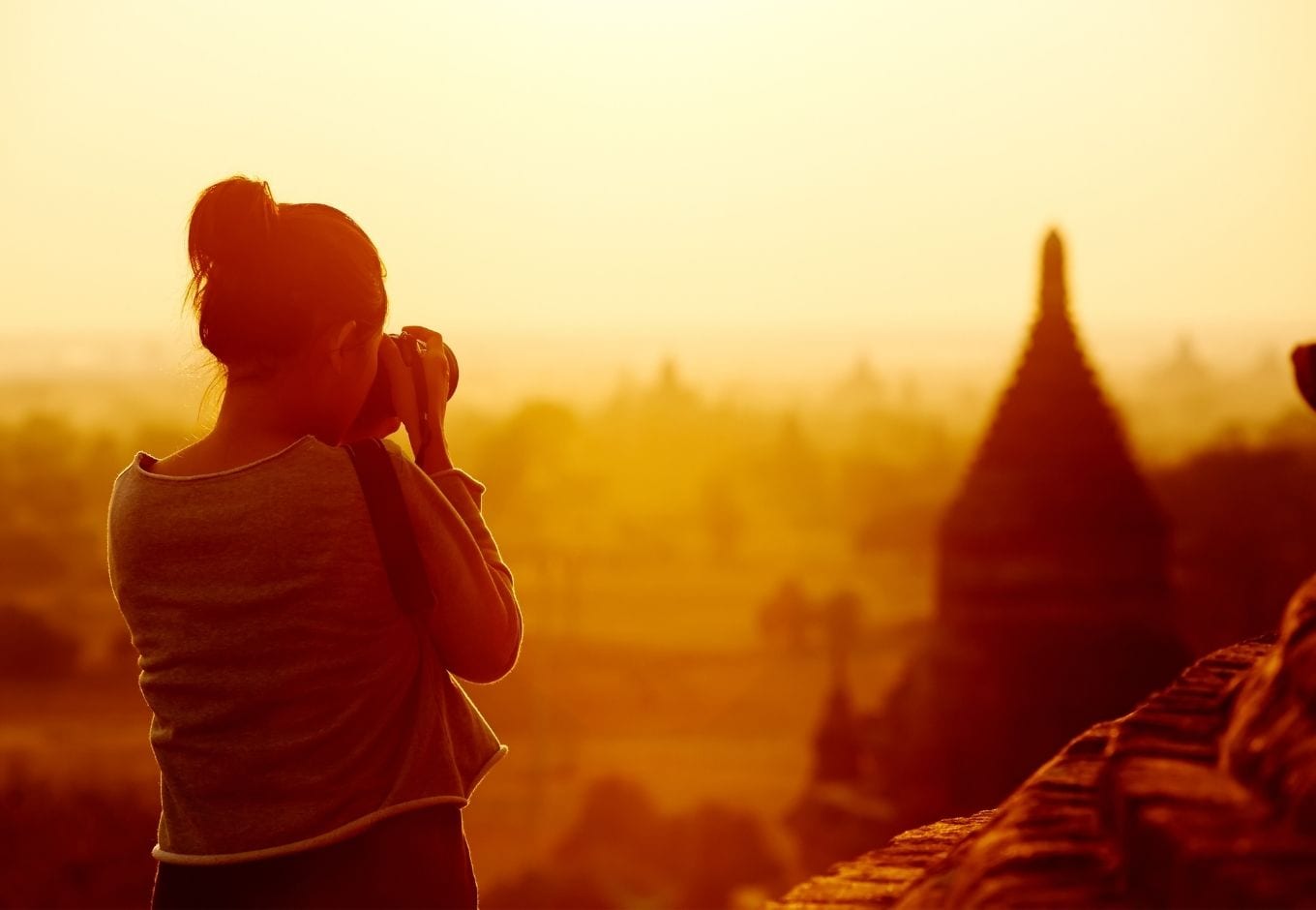 Female traveler photographing the Bagan Temples, at Myanmar.