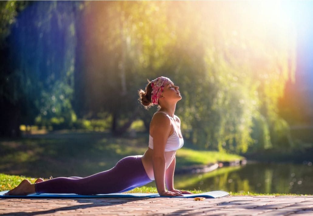 Woman doing yoga in an outdoor area.