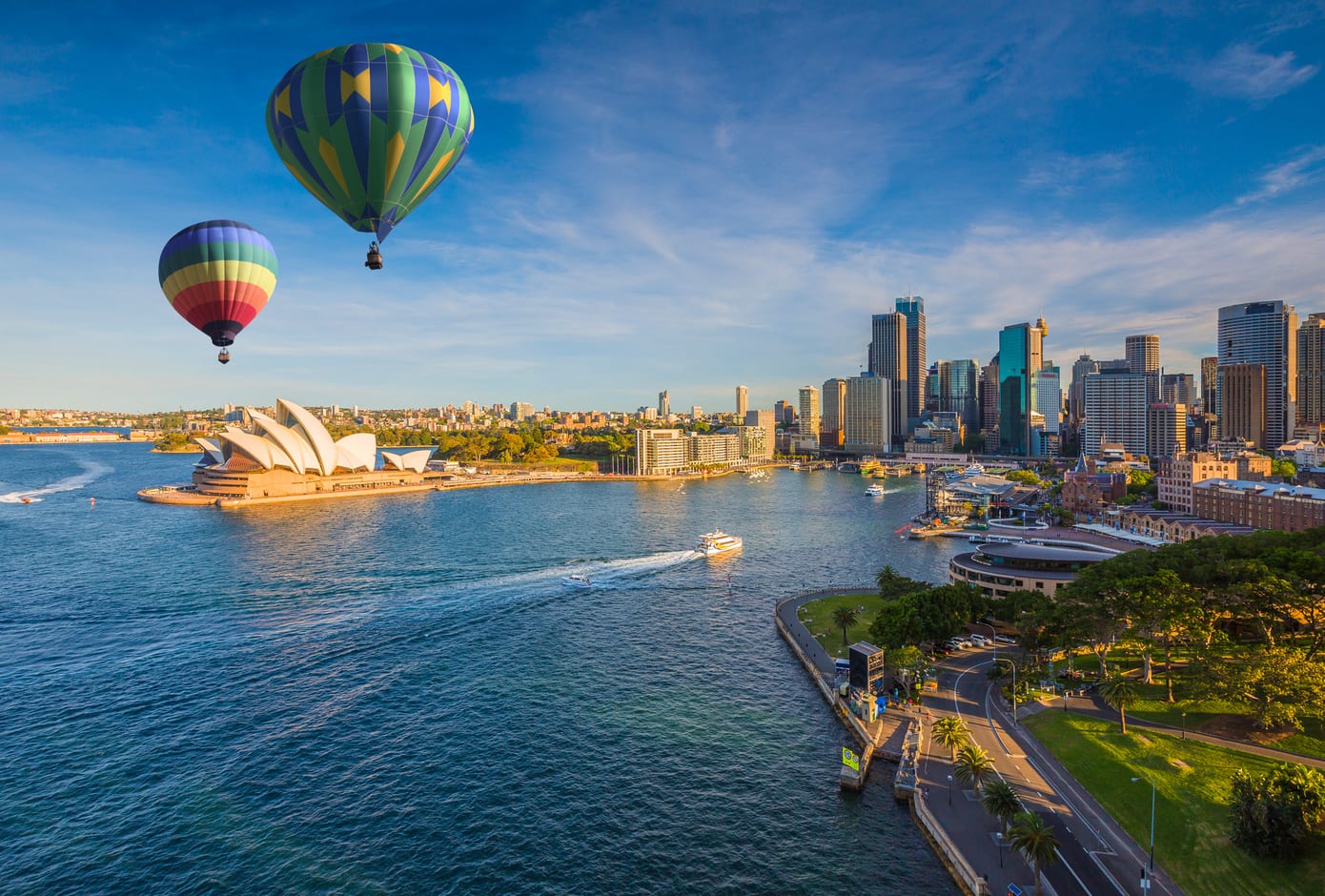 Two hot air balloons flying over the Sydney bay, in Sydney, Australia.