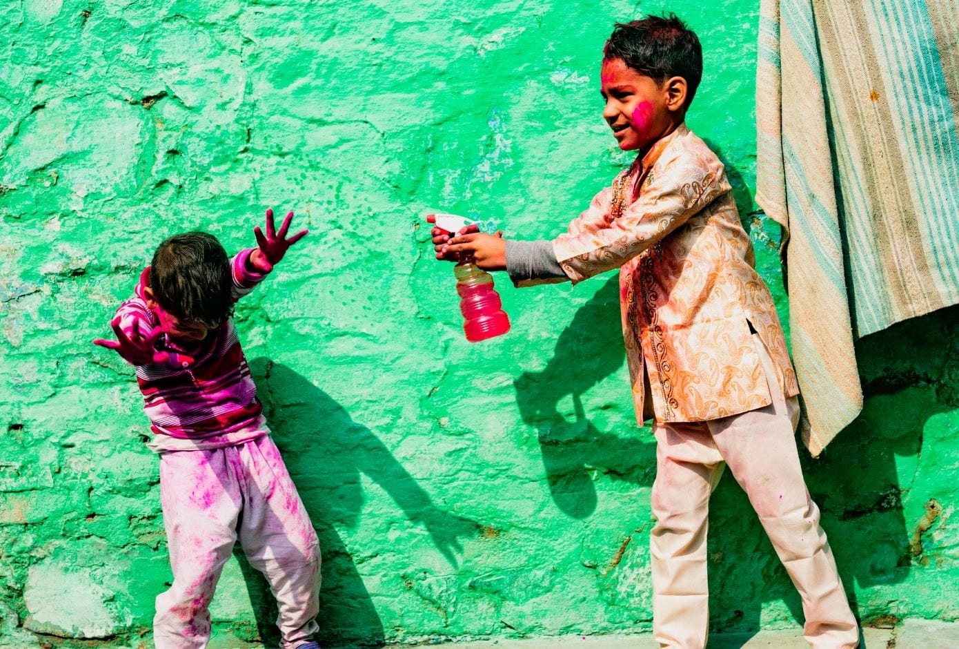 holi travel guide kids playing with pistols children playing with water guns
