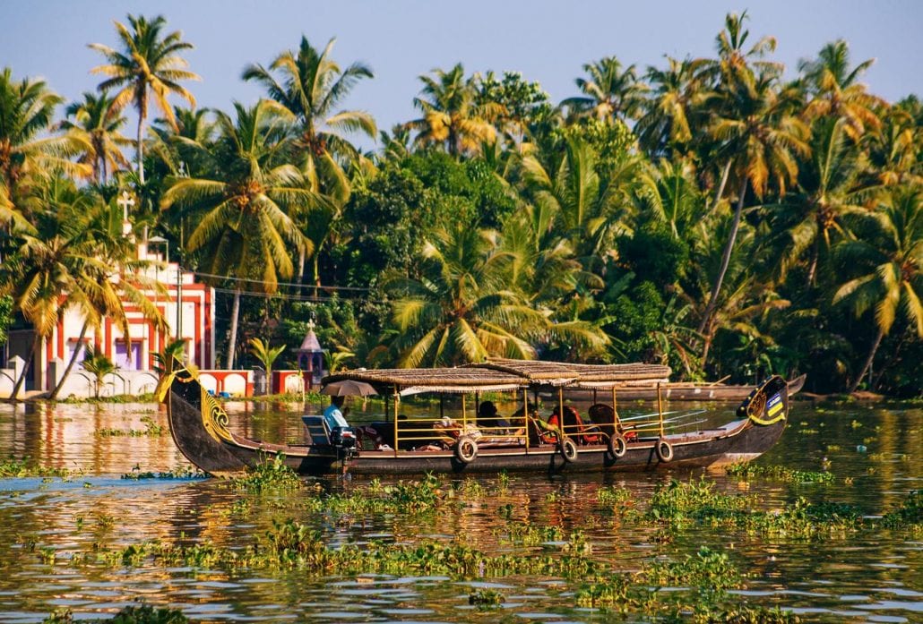 A houseboat transports tourists through the backwaters in Alleppey, India. 