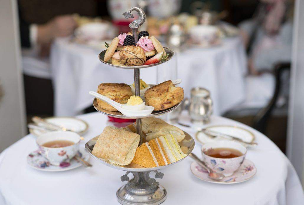 A typical British Afternoon Tea with scones, finger sandwiches and pastries.