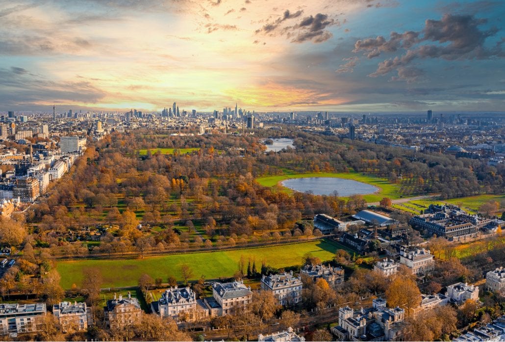 The Hyde Park dotted with orange autumn trees, in London.