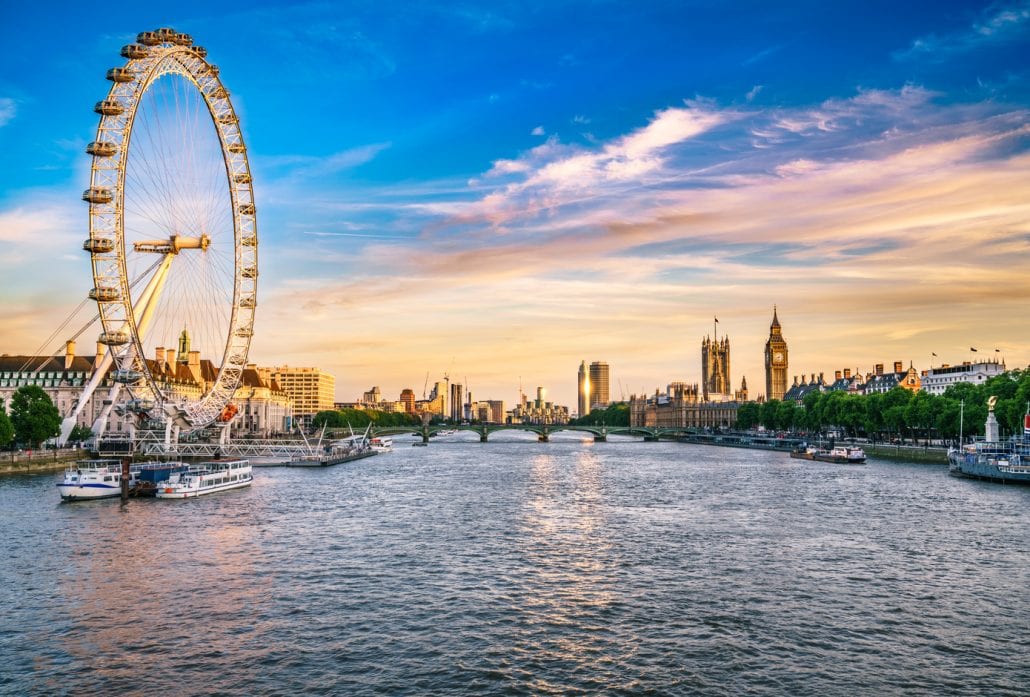 The London Eye overlooking the River Thames with the Big Ben at the backgorund.