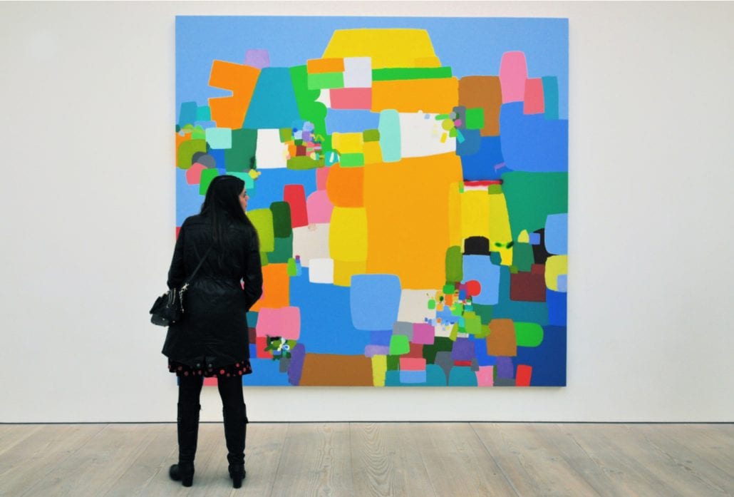 A visitor views Amansalva, a painting by Costa Rica artist Federico Herrero at the Saatchi Gallery in Chelsea, London, UK.
