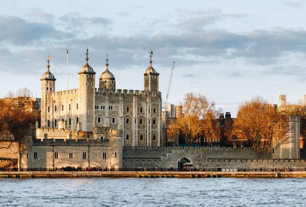 Tower of London at sunset, surrounded by autumn trees.