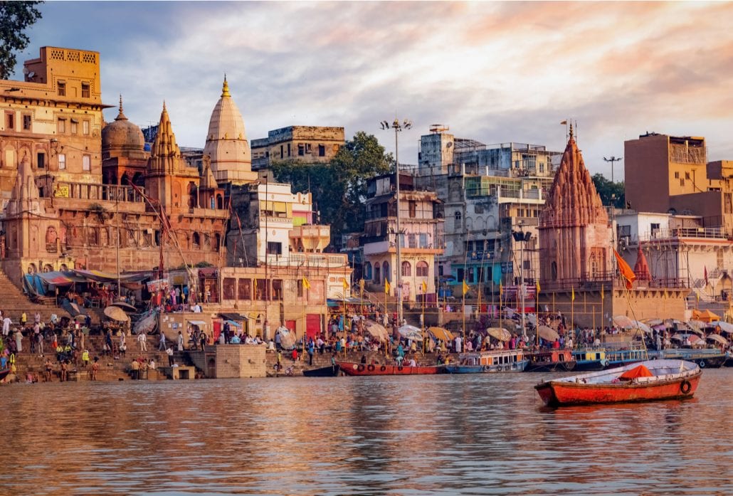 Ancient Varanasi city architecture at sunset overlooking the River Ganges.
