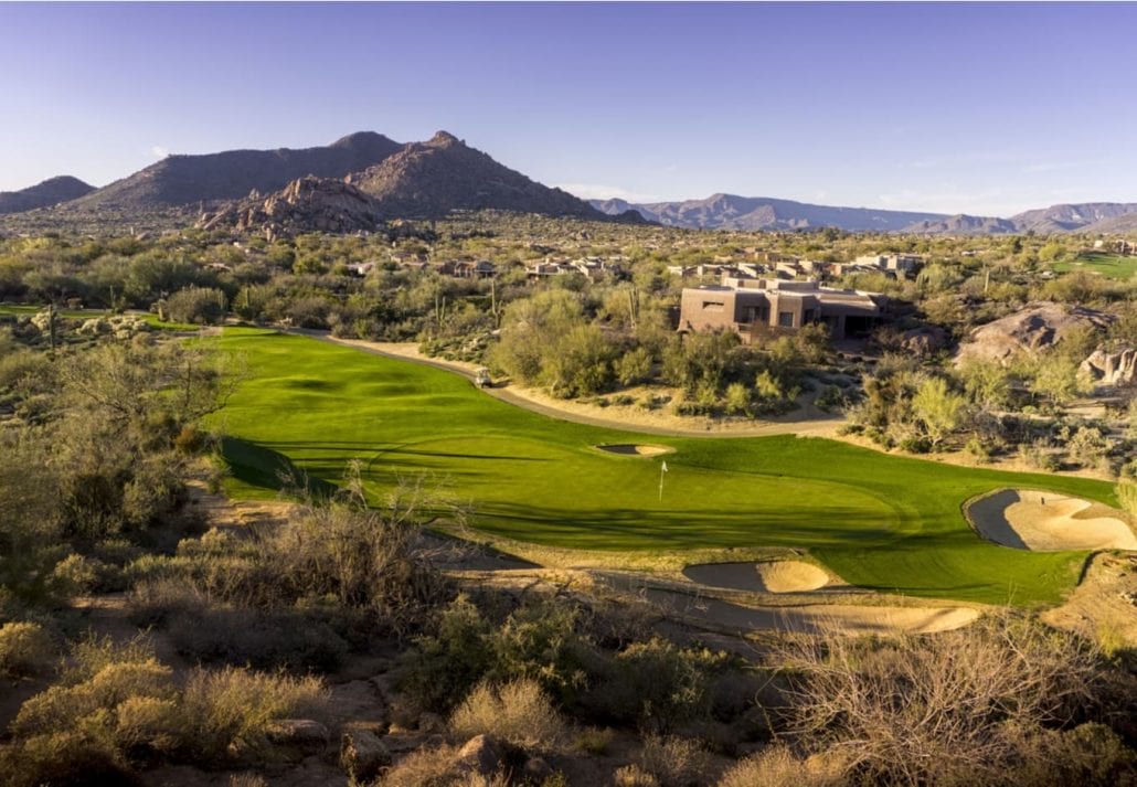 Wide Angle View High Point Of View Of Desert Golf Course Landscape Community With Mountains In Background.