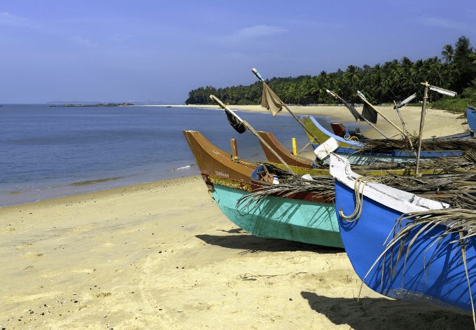 cherai-beach-kerala-best-india-beaches (wecompress.com) | CuddlyNest Travel Blog Cherai Beach, Thottada, Kannur, Kerala, India. Fishing boats moored on the beach on a beautiful sunny day along the Malabar Coast overlooking the Arabian Sea.