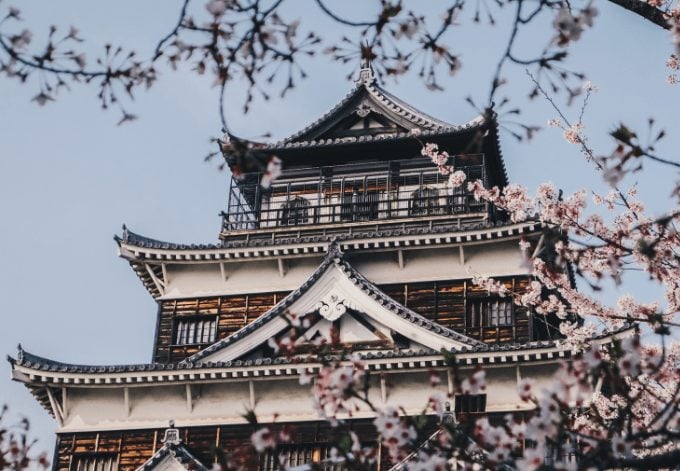 The Hiroshima Castle framed by cherry blossom trees, in Hiroshima, Japan.