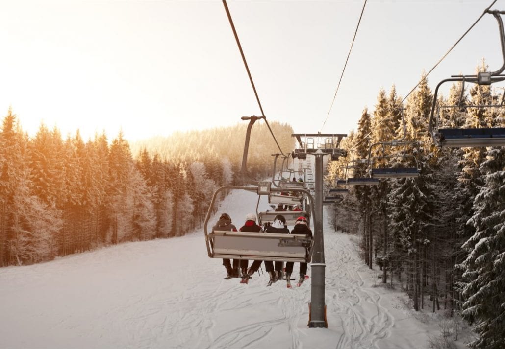 People are posing on the cable car in the mountains