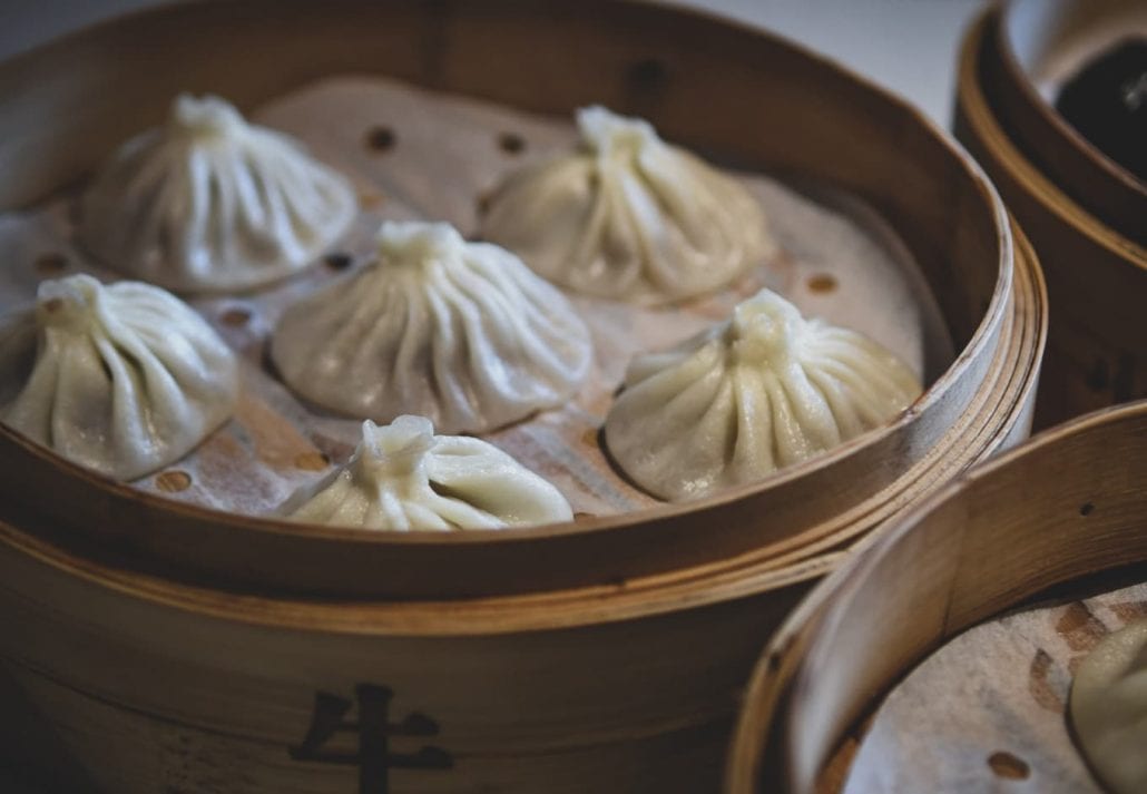 Chinese dumplings in a bamboo steamer box.